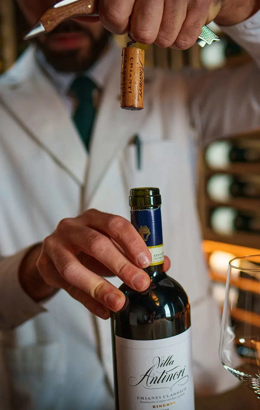 STERLING bar staff opening a bottle of wine